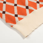 Pull en tricot à losanges orange pour homme, style universitaire des années 70