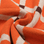 Pull en tricot à losanges orange pour homme, style universitaire des années 70